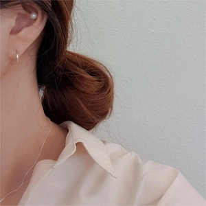 Minimalist 925 sterling silver hoop earrings and pearl studs set worn by a model