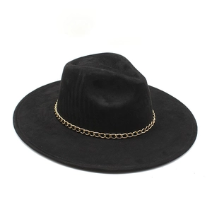 Detail of black fedora hat with wide brim and decorative chunky gold chain accent