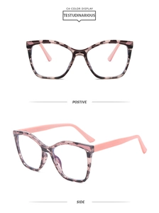 Detail view of square cat-eye glasses frame in tortoise shell print and pink temples