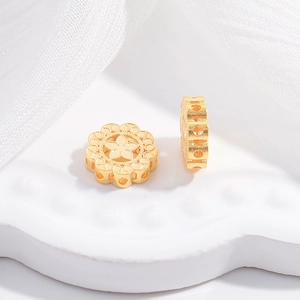 Macro shot of two golden hollow flower spacer beads for DIY jewelry bracelet making