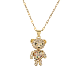 Articulated golden bear pendant necklace with sparkling micro-pave zircons on white backdrop
