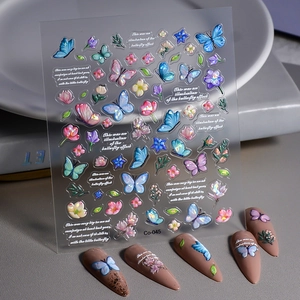 Detail of 5D embossed nail stickers featuring colorful butterflies and floral textures