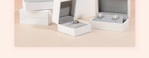 White textured jewelry boxes with gray velvet interior for rings and earrings