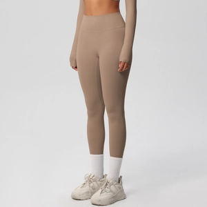 Detail of high-waisted seamless yoga leggings and long sleeve crop top in khaki brown