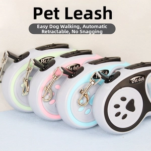 Close-up of four retractable pet leashes with bone patterns and automatic control buttons