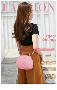 Detailed macro view of pink quilted half-round bag with golden clover logo hardware