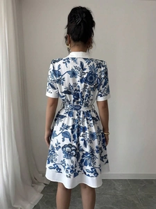 Back view of a blue and white porcelain floral summer dress with a waist tie belt