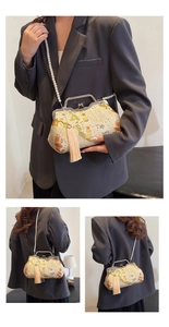 Detail of vintage beige floral brocade shell bag with pearl strap and long silk tassel
