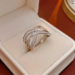 Detailed macro view of criss-cross silver ring with shimmering cubic zirconia inlay