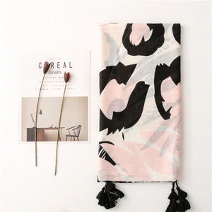 Pink and black tropical print cotton-linen scarf with elegant tassels on white background