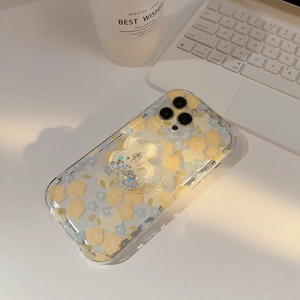 Detail of floral iPhone case with glitter flower stand and Jasmine text on desk