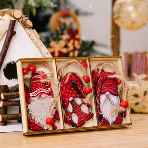 Detailed view of red wooden Christmas gnome ornaments with jute twine in a wooden gift box