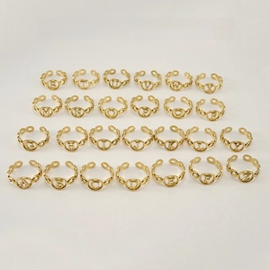 Macro shot of 26 gold alphabet rings from A to Z with hollow chain band details