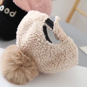 Detail view of beige teddy fleece baseball cap with large faux fur pompom and GOOD embroidery