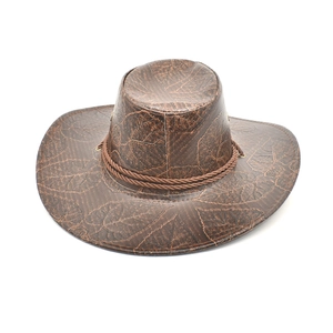 Detail of brown cowboy hat featuring leaf vein embossing and braided rope band decoration