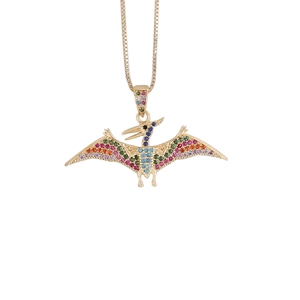 Detailed close-up of a golden pterosaur pendant set with vibrant multicolor crystals