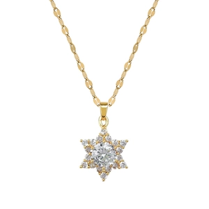 Gold snowflake necklace with cubic zirconia pendant on polished clavicle chain