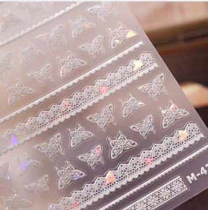 Detail of 3D embossed butterfly nail stickers with holographic laser gold finish