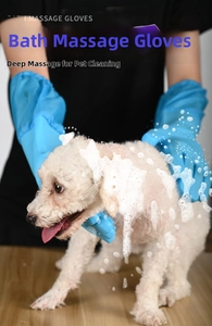 Close-up of blue silicone pet grooming glove massaging a dog with rich soap bubbles