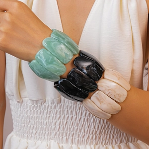 Detail of chunky marble texture resin bracelet in mint green, black and ivory tones