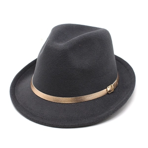 Close-up of a charcoal grey fedora hat with a golden metallic buckle strap detail