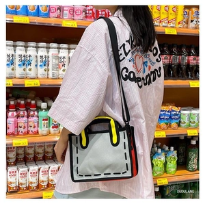 Detail view of 2D pop art canvas tote bag with bold black outlines and yellow handles