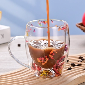 Double-wall glass mug with colorful dried flowers and handle for coffee and milk