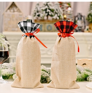 Detail of red and black plaid burlap wine bottle gift bags with festive ribbons