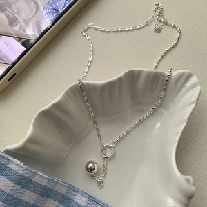 Detailed close-up of 925 sterling silver bead necklace in a shell jewelry tray