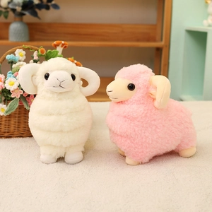 Cute plush sheep dolls in white and pink with fluffy texture and spiral horns on a shelf