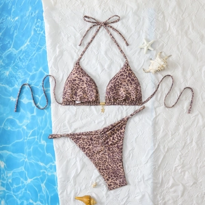 Detail of leopard print bikini with halter top, side ties, and a gold star pendant