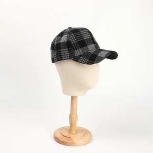 Detail view of the gray plaid wool baseball cap on a professional mannequin head stand