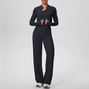 Detail of black athletic jacket with thumbhole cuffs and high-waisted yoga pants set