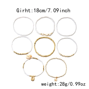 Detail of 8-piece bohemian anklet set with starfish, sea shells and white beads