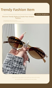 Macro view of metallic oval sunglasses with diamond heart decor and gradient lenses