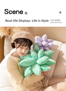 Close-up of soft succulent plush pillows held by a model to show texture and scale