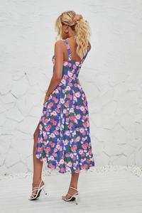 Detail of blue floral sun dress featuring a high side slit and sleeveless strap design