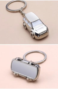 Detailed close-up of a silver F1 racing car metal keychain with a polished mirror finish