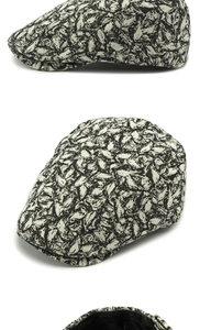 Detail of black and white leaf pattern fabric on a vintage style newsboy flat cap