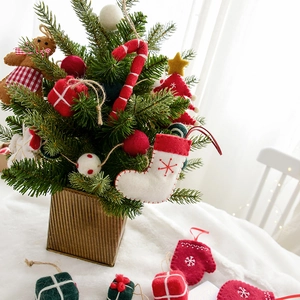 Mini Christmas tree with handmade wool felt ornaments in a vintage metal pot for decor