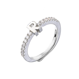 Detail of adjustable silver ring featuring letter R with sparkling cubic zirconia stones