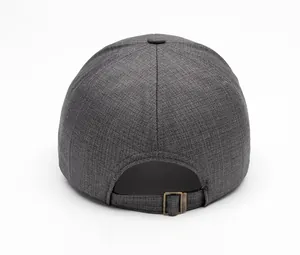 Detail of dark grey baseball cap showing textured fabric and bronze adjustable buckle