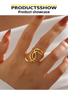 Close-up of gold-plated stainless steel triple interlocking wave ring on finger