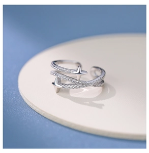 Detailed close-up of multilayer silver star ring with micro-set cubic zirconia stones