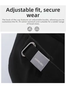 Detail view of adjustable silver metal buckle and strap on back of black cotton baseball cap