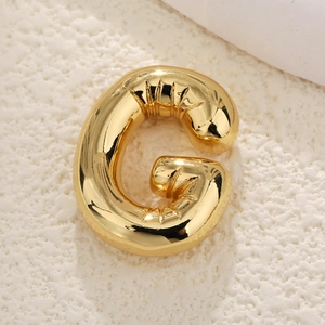 Macro shot of 18k gold plated balloon style letter G pendant with glossy finish