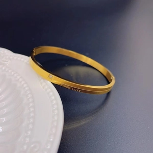 Golden titanium steel bangle with Endless Love engraving and embedded cubic zirconia stone