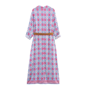 Back view of a long-sleeved V-neck maxi dress with geometric floral patterns and belt