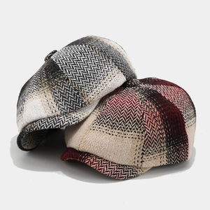 Classic herringbone tweed newsboy caps in grey and burgundy colors for a vintage look