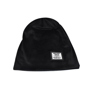 Solid black chenille beanie for women with white woven label on white background